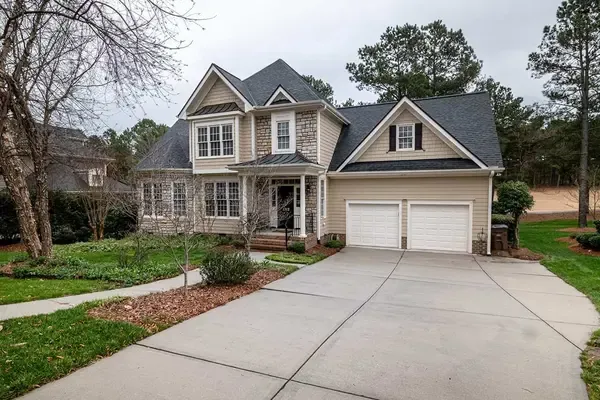 A charming two-story house with a steeply pitched roof