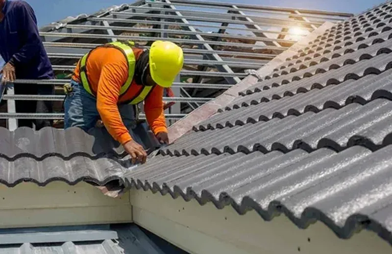 Jersey City A construction worker installs corrugated roofing tiles