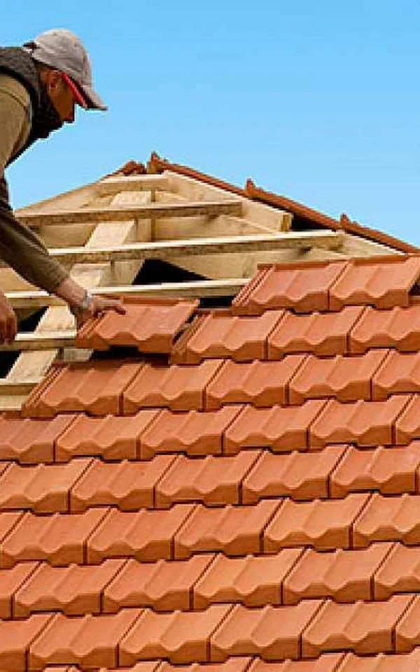 Newark Worker installing roof tiles on wooden structure