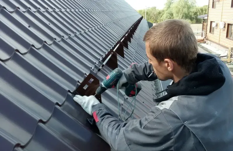 A worker installs roofing panels