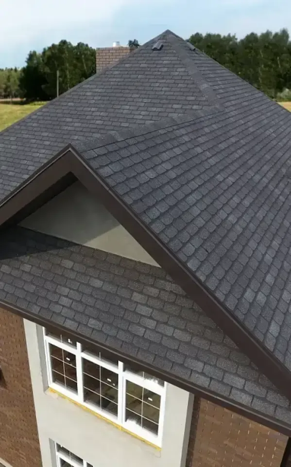 Aerial view of a modern home's roof featuring dark shingles