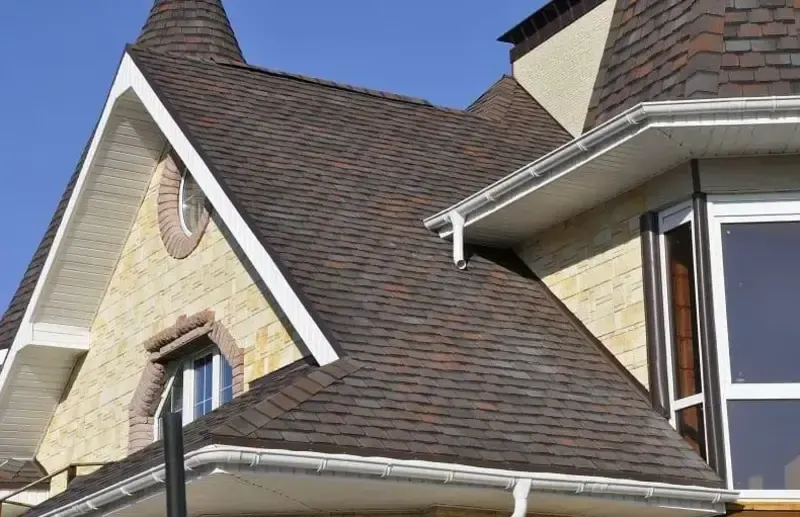 Close-up of a house roof featuring dark shingles