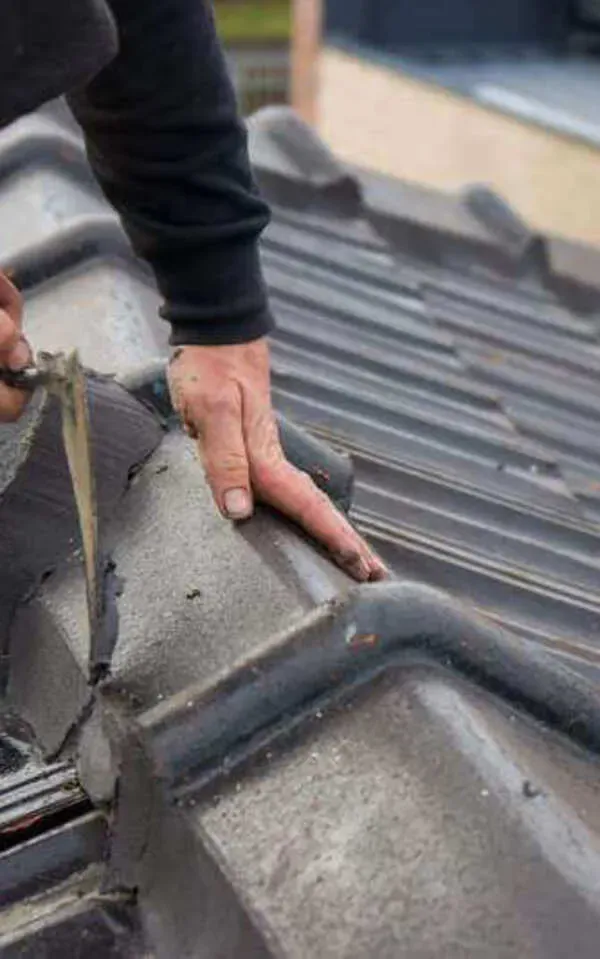 nutley Person working on a tiled roof with tools